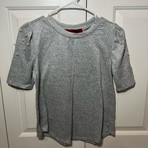 Blouse with pearls on shoulders.